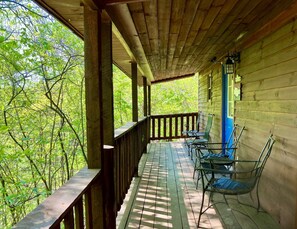 A wooden porch with a railing, a table, and two chairs. - Mammoth Arch | Hot Tub | RRG | Near Nada Tunnel (Stanton)