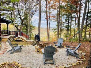 A cabin with a deck, outdoor seating area with Adirondack chairs, and a fire pit. - Terrapin Station - Valley View, Hot Tub, Game Room (Rogers)