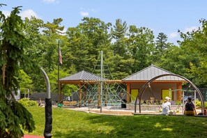 A playground with climbing structures, a gazebo, and a covered seating area. - Three Pines Hideaway (Glen Arbor)