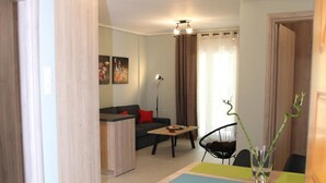 A modern living room with a dining area, a kitchen, and a bathroom. - Ariadni s Athenian Apartment (Athens)