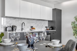 Penthouse One-Bedroom Apartment | Private kitchen | Fridge, stovetop, dishwasher, toaster