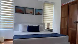 A bedroom with a bed, a nightstand, and a wardrobe. - "Beach Haven Nilaveli" a home away from home (Nilaveli, Eastern Province, Sri Lanka)