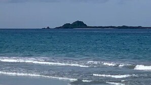 A beach with calm water and a distant island. - "Beach Haven Nilaveli" a home away from home (Nilaveli, Eastern Province, Sri Lanka)