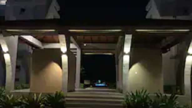 A building entrance at night with steps leading up to a door, surrounded by plants and illuminated by lights. - "Beach Haven Nilaveli" a home away from home (Nilaveli, Eastern Province, Sri Lanka)