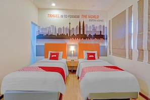 A hotel room with two beds, a city skyline mural, and a quote by Burton Holmes. - Super OYO Capital O 3905 Graha 100 Guest House Syariah (Surabaya)