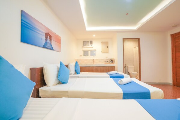 A hotel room with two beds, a bathroom, and a view of the sea. - ARZO Hotel Premier (Makati)