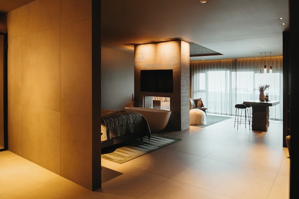 Deluxe Suite | Living room | 55-inch Smart TV with cable channels, TV, heated floors