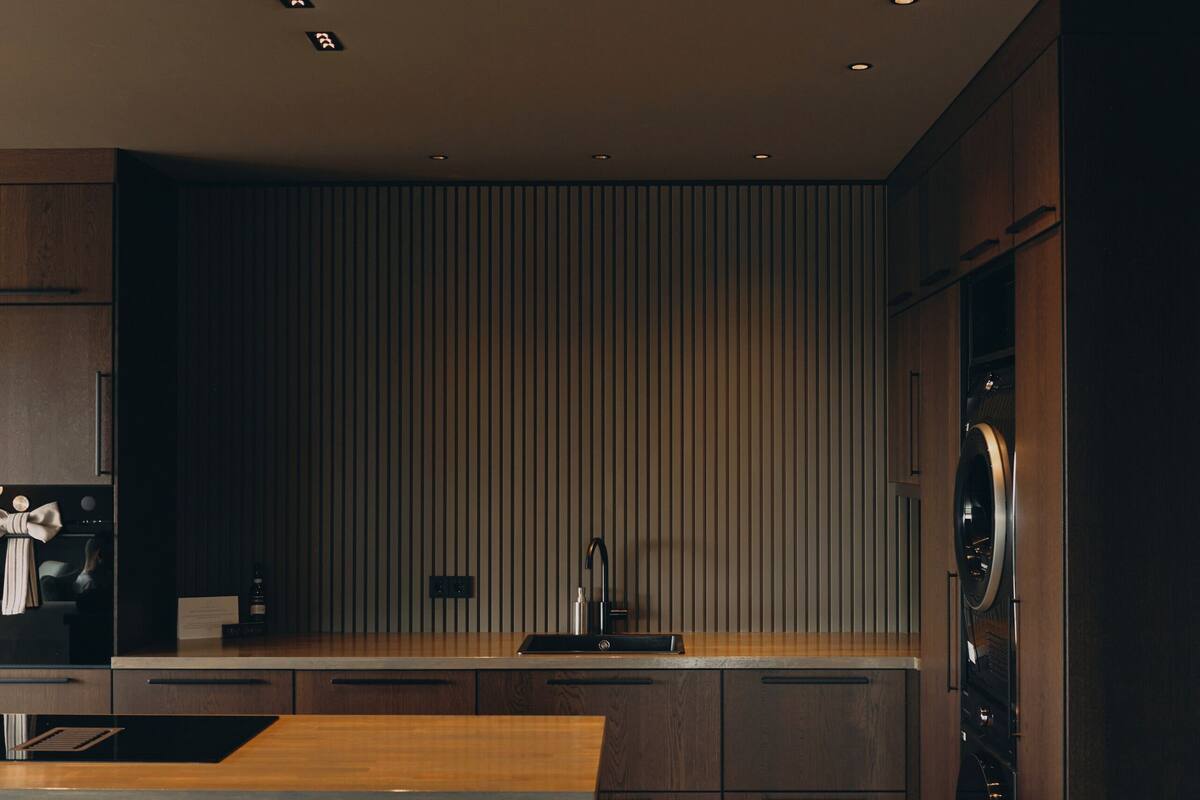 A modern kitchen with a central island, built-in appliances, and a sleek design.