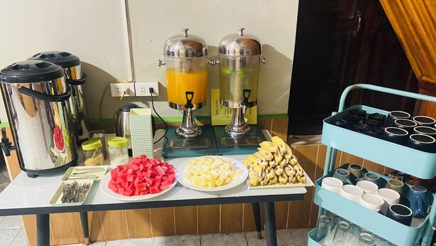 A breakfast buffet with various food items and beverages. - Luang Prabang Hostel (Luang Prabang)