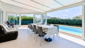 A sunlit patio with a dining table, chairs, and a sofa. - Le Fenouiller, Spacious house for 6, swimming pool (Le Fenouiller)