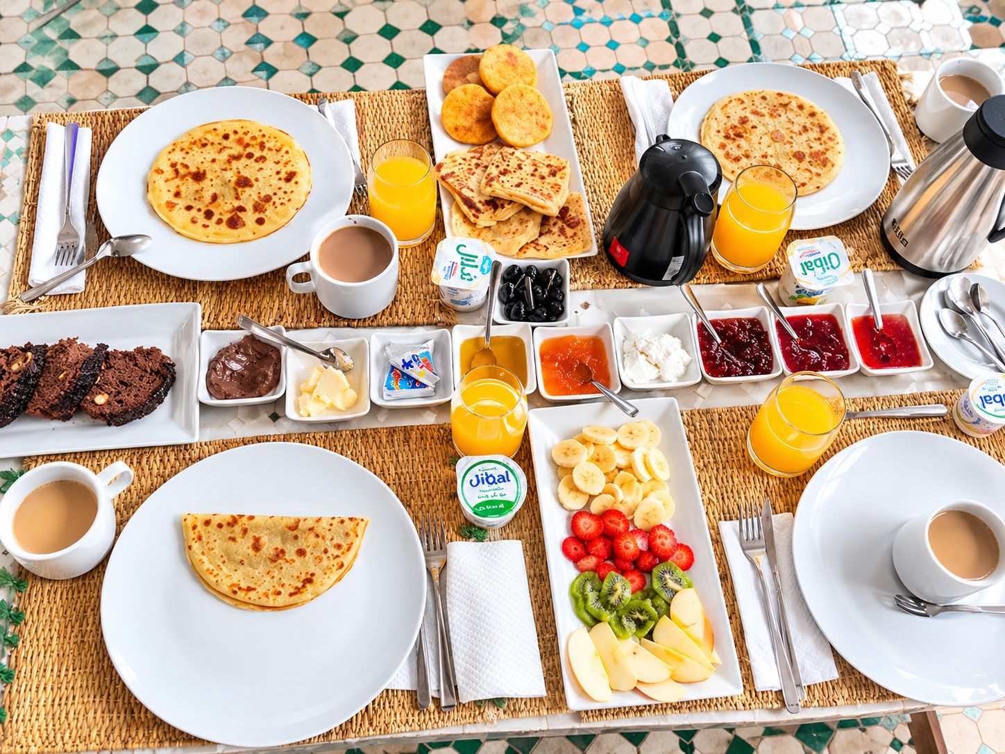 A breakfast buffet with various food items and beverages.