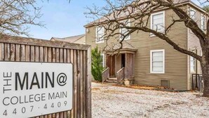 A sign for The Main College Main with a contact number. - GIG'EM: Walk to A&M, Comfy King Bed (Bryan)