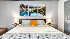 A bedroom with a large bed, two bedside lamps, and a ceiling fan. - Denali: 2 Bedroom, Walk to A&M, Comfy King Beds (Bryan)