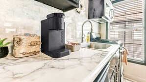 A modern kitchen with a built-in coffee maker, a sink, and a window with blinds. - Tribeca: So Fun! Walk to A&M, Comfy King Beds (Bryan)