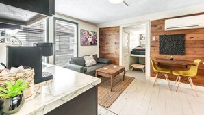 A compact living space with a kitchen, dining area, and a small sleeping area. - Tribeca: So Fun! Walk to A&M, Comfy King Beds (Bryan)