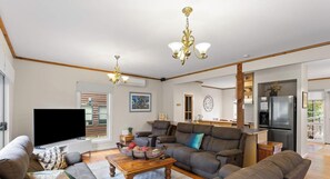 A modern living room with a sofa, a television, and a coffee table.
