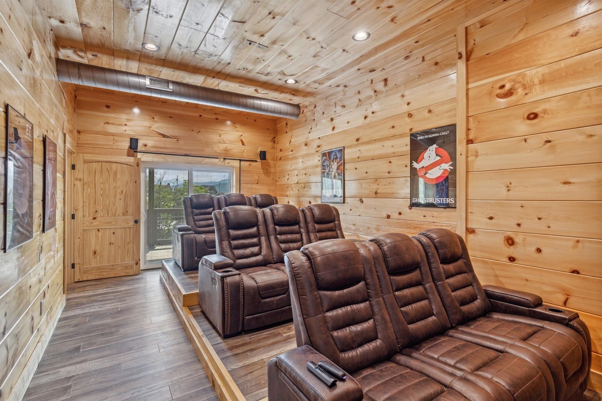 A wooden interior with massage chairs and a poster of Ghostbusters.