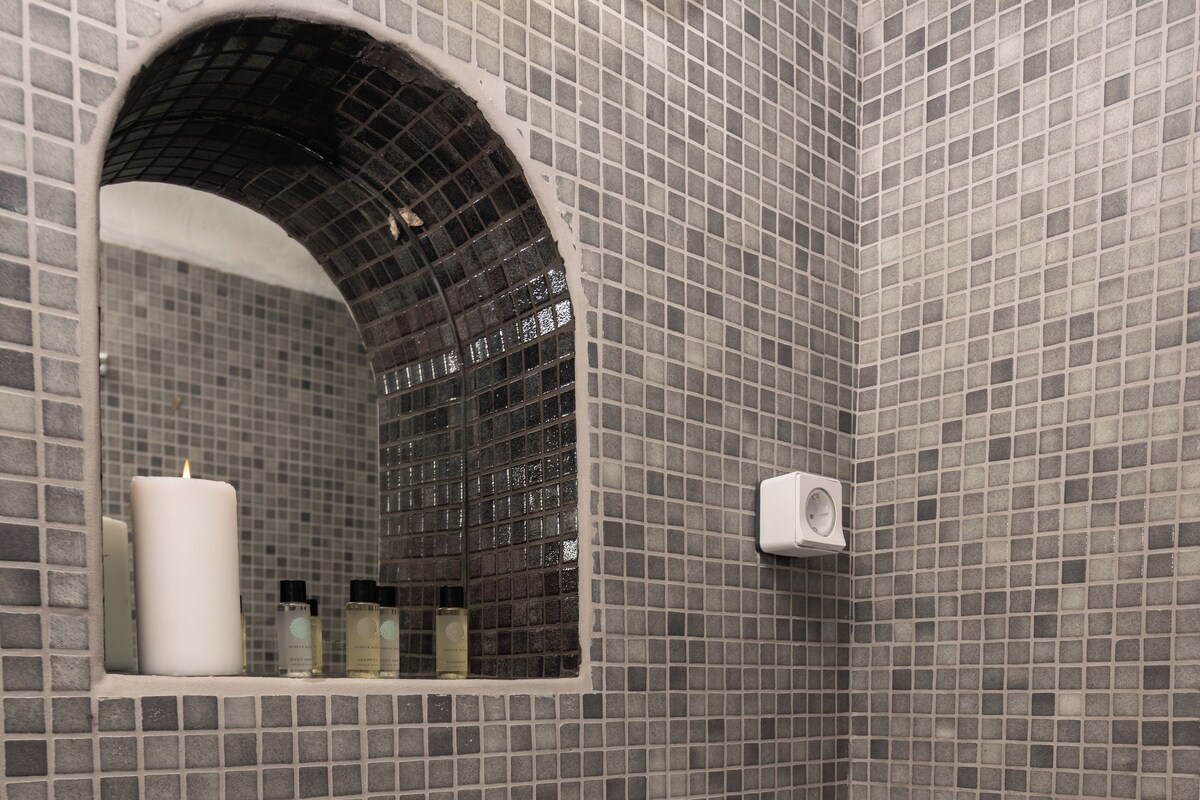 Ein Badezimmer mit einem weißen Waschbecken, einem Spiegel und einem Handtuchhalter.