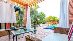A covered patio area with a pool, outdoor furniture, and a fountain. - Villa Gardens Diafa - 8 rooms (Lahebichate)