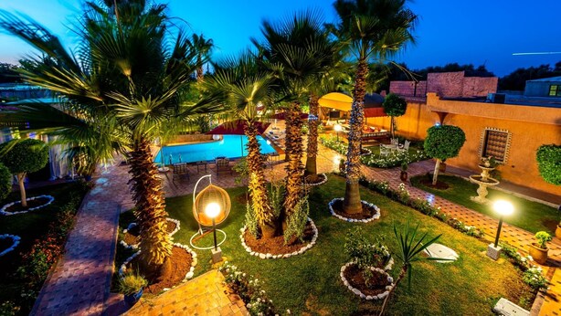 A well-lit outdoor area with a swimming pool, palm trees, and a paved walkway. - Villa Gardens Diafa - 8 rooms (Lahebichate)