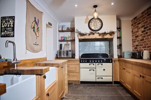 Enjoy cooking in this well-equipped kitchen with a central stove, microwave, and ample storage.