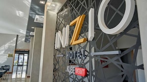 A hotel entrance with a modern design, featuring a geometric pattern and the name 'INZIO HOTEL' prominently displayed. - Hotel Inizio (San Francisco)