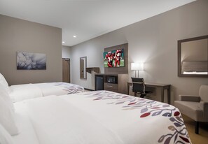 A hotel room with two beds, a desk, a TV, and a mirror. - Red Roof Inn Lancaster, TX (Lancaster)