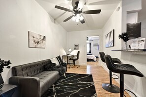 Signature Apartment, 1 King Bed, Kitchen | Living area | 55-inch Smart TV with digital channels