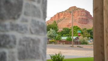 A view of a mountain with a stop sign in the foreground.