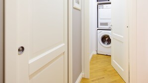 A narrow hallway with a washing machine and dryer in the background. - Closed structure, not existing (Potenza)