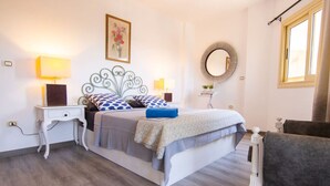 A bedroom with a bed, bedside tables, a chair, a mirror, and a window. - Lovely 3BR Apartment in Heart of Mohandseen (Giza Governorate)
