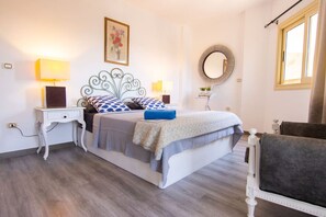 A bedroom with a bed, bedside tables, a chair, a mirror, and a window. - Lovely 3BR Apartment in Heart of Mohandseen (Giza Governorate)