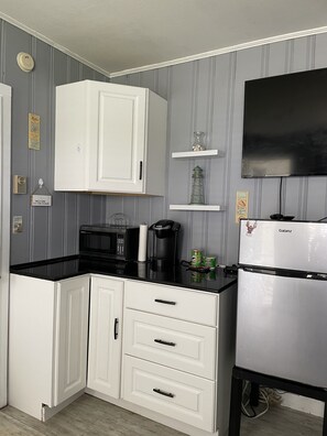 Fridge, microwave, coffee/tea maker, cookware/dishes/utensils