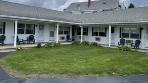 A motel with two-story buildings, each with a covered porch and multiple windows.