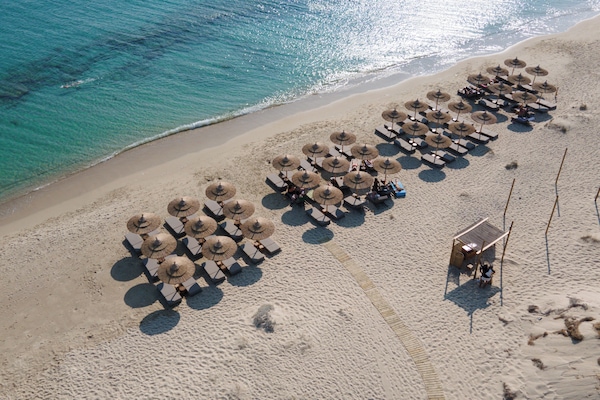 On the beach, white sand, sun loungers, beach umbrellas