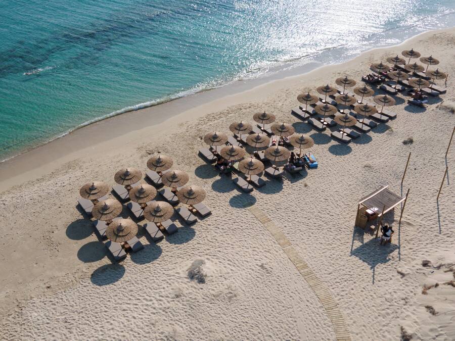 On the beach, white sand, sun loungers, beach umbrellas