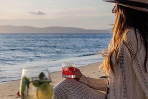 On the beach, white sand, sun loungers, beach umbrellas