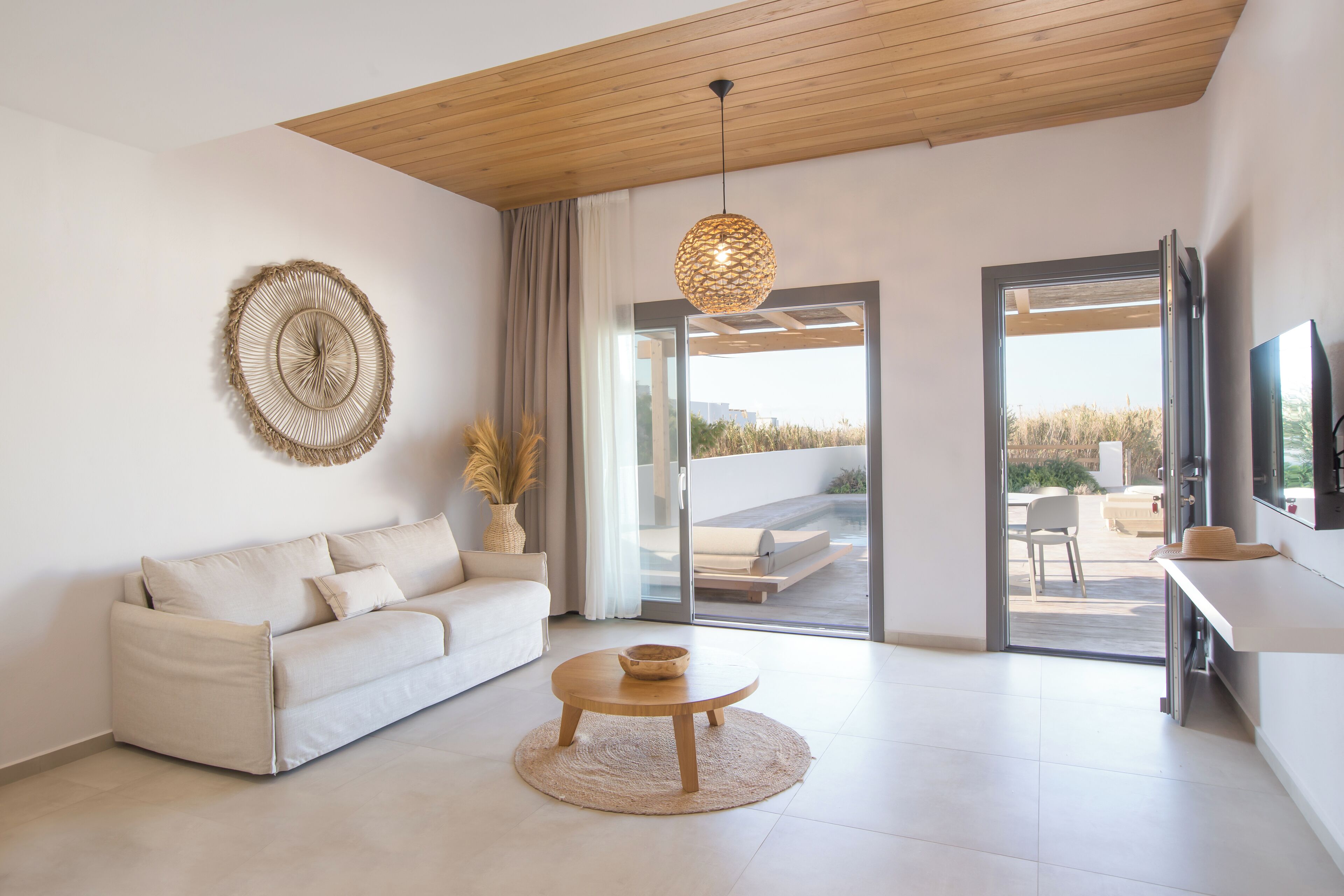 A modern living room with a sofa, coffee table, and a decorative wall piece.