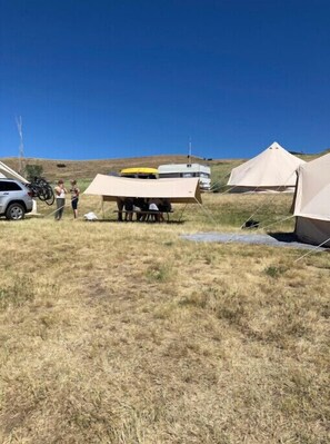 Guests can pitch their tents and park their vehicles on this spacious grassy field.