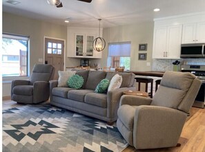 Relax in this stylish living room with a sofa, dining area, and fully equipped kitchen.