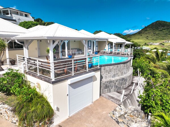 A heated pool, sun loungers