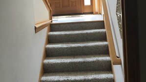 A staircase leading to a wooden door with a glass panel. - Location: By Target Center, US Bank Stadium, Target Field & Blaine Sports Ctr! (Blaine)