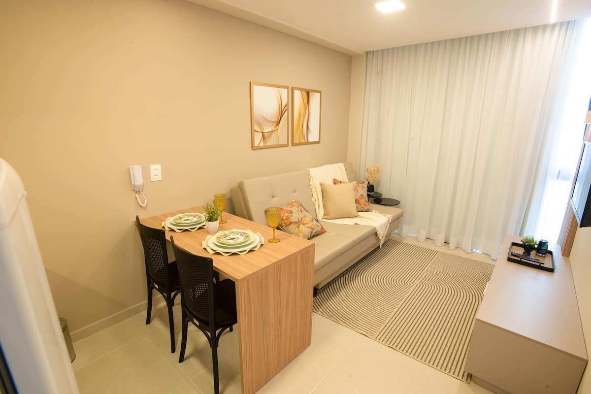 A modern living room with a dining area, a sofa, and a coffee table.