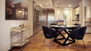 A modern dining area with a round table, dark chairs, and a gold-framed glassware cart. - ▶Cool Apt in Condesa 3BD, 3BA (Ciudad de México)
