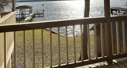 Peaceful lake front home with wrap around porch and relaxing views!