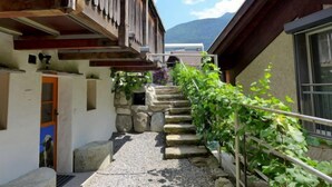 A narrow stone staircase leading up to a wooden building with a balcony. - Tschingeli by Interhome (Gampel-Bratsch)