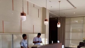A reception desk in a modern lobby with a clean, minimalist design. - Centrio Tower 926 (Cagayan de Oro)