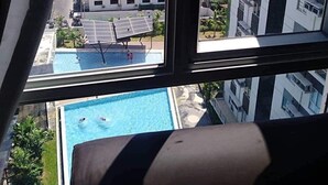 A high-rise building with a view of a swimming pool and a parking lot. - Centrio Tower 926 (Cagayan de Oro)