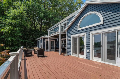 Serene lakefront retreat with an expansive deck, dock access, game room, & AC