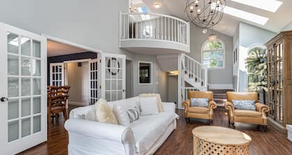 Serene lakefront retreat with an expansive deck, dock access, game room, & AC